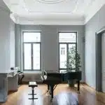 black grand piano near window